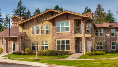 Exterior view of a senior living facility surrounded by greenery