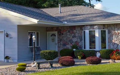 Exterior view of a senior living facility with landscaped garden