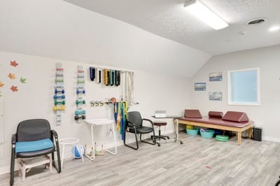 Therapy room with exercise equipment and tables