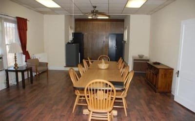 RiverSide Meadows, senior living in Jeffersonville, IN — Empty dining room with a large table and chairs