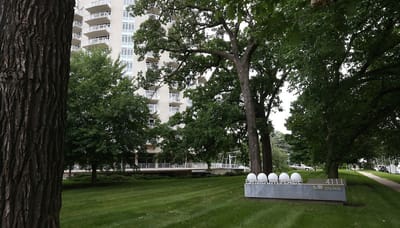 Exterior view of a senior living facility surrounded by trees