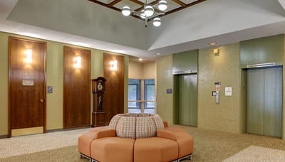 Bright, inviting lobby area with seating and elevators
