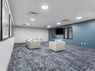 Bright common area with sofas and TV