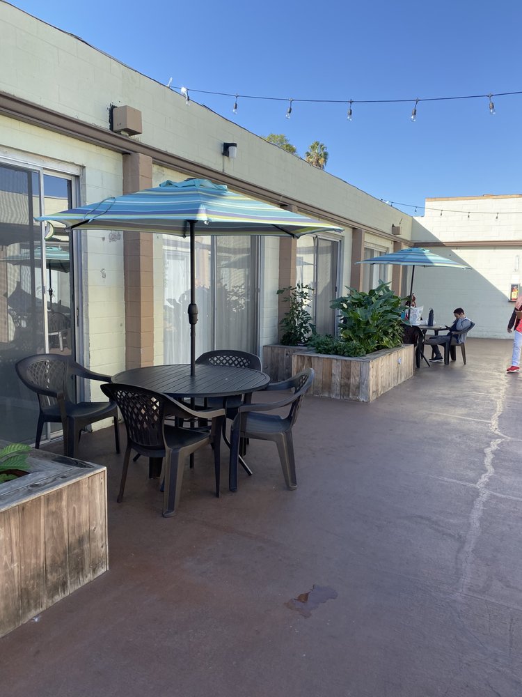 Outdoor seating area with tables and umbrellas