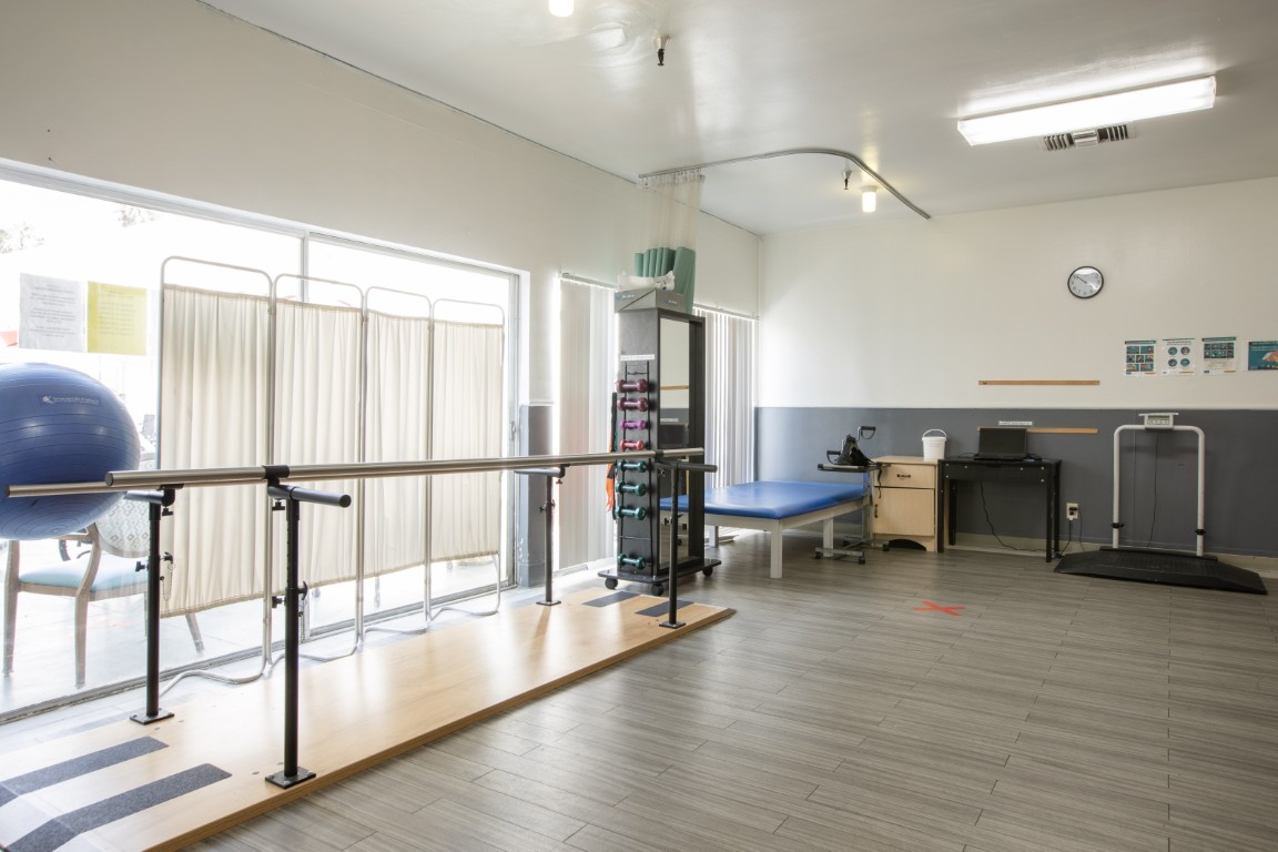 Physical therapy room with equipment and natural light