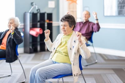 Residents participating in a seated exercise class
