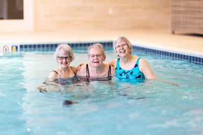 Three residents enjoying a pool activity