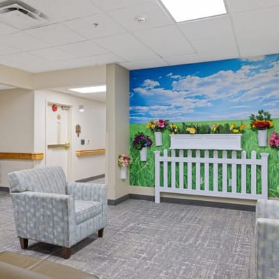 Bright common area with floral wall mural and seating