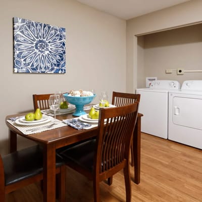 Dining area with a table setting and laundry machines