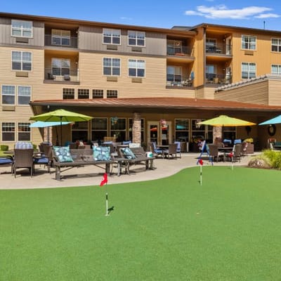 Outdoor seating area with mini-golf and colorful umbrellas