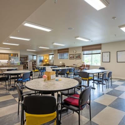 Bright and spacious dining room with tables and chairs