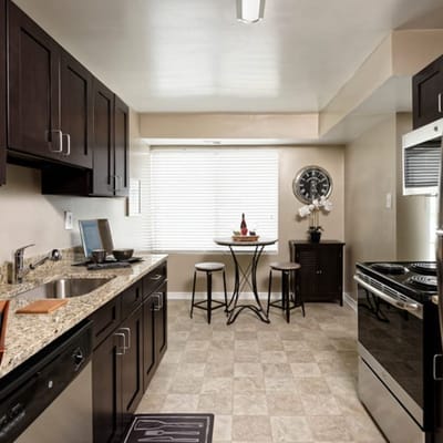 Modern kitchen with dark cabinets and a small dining table