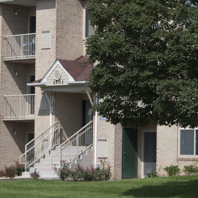 Exterior view of the facility with landscaping and steps