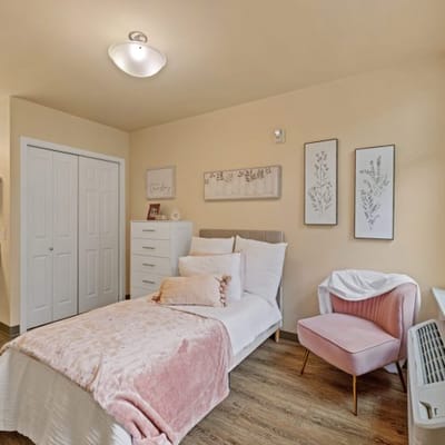 Cozy interior of a resident's room with bed and decor