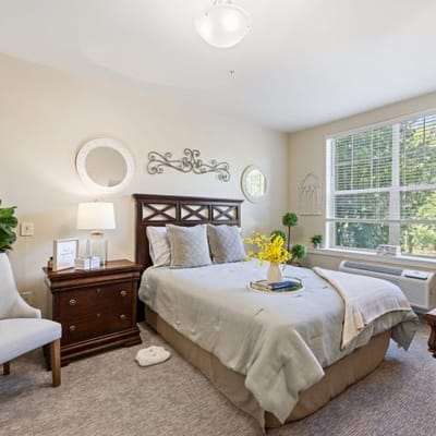 A well-appointed resident bedroom with natural light