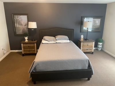 A well-furnished private resident room with a bed and lamps