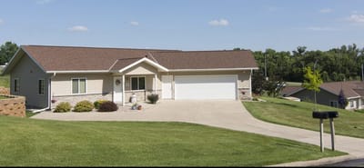 Exterior view of a senior living facility with well-maintained landscaping