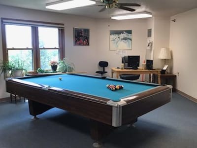 Interior view of a recreational room with a pool table