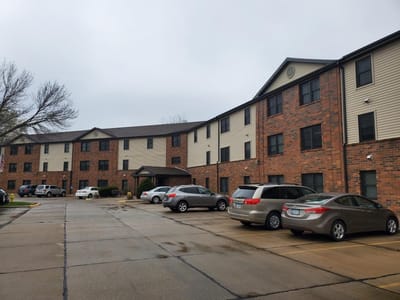 Exterior view of Evergreen Terrace Senior's building and parking area