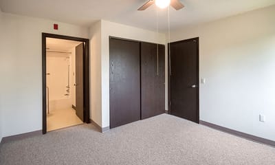 Empty interior room with closet space and a ceiling fan