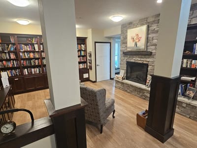 A cozy common area with bookshelves and seating