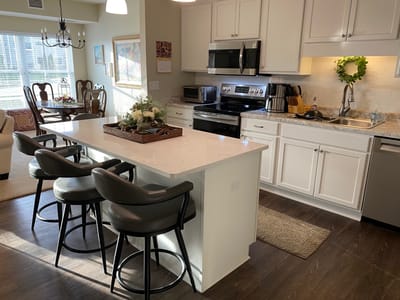Bright kitchen area with modern appliances and seating
