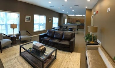 Common area with seating and kitchen in view