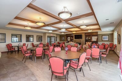 Bright dining area with red chairs and tables