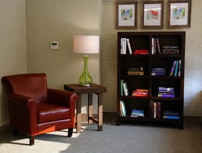 Cozy reading corner with bookshelves and a lamp