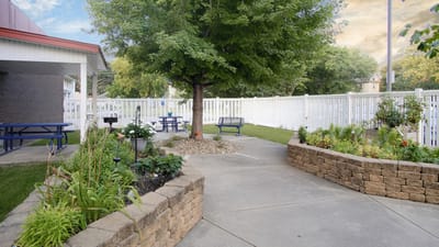 A well-maintained outdoor area with seating and gardens