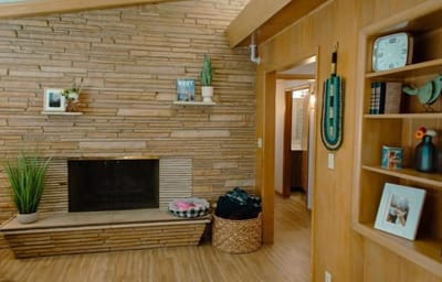 Cozy common area with stone wall and fireplace