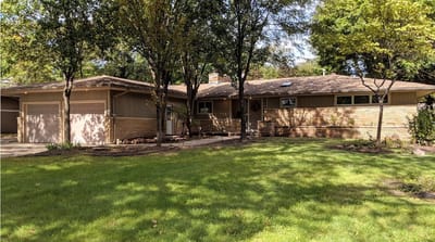 Exterior view of a senior living facility with lawn