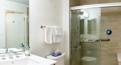 Modern bathroom with shower and amenities.