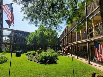 A beautiful outdoor garden area with flags and greenery