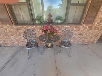Outdoor seating area with flowers and chairs