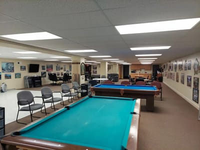 Interior view of a common area with pool tables and seating