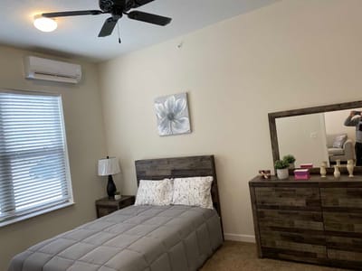 Cozy private resident room with bed and dresser