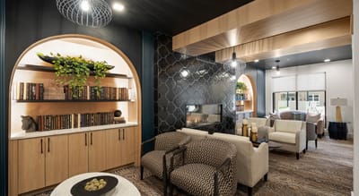 Cozy common area with seating and bookshelves
