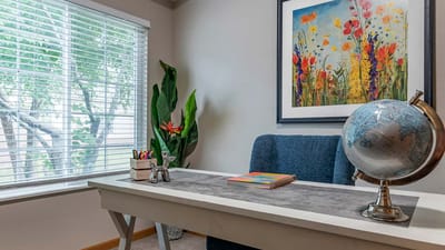Bright corner of an interior room with a desk and artwork