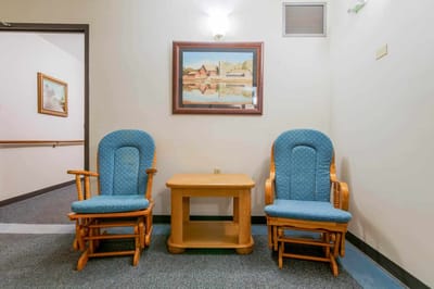 Cozy common area with blue rockers and a painting