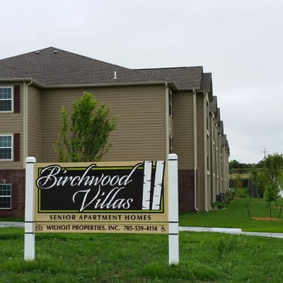 Sign for Birchwood Villas with building in background