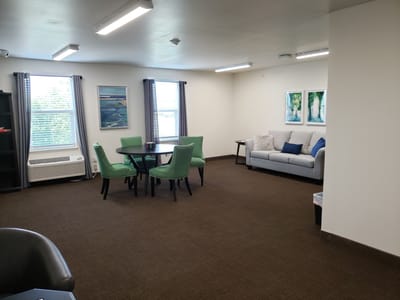 Bright common area with seating and artwork