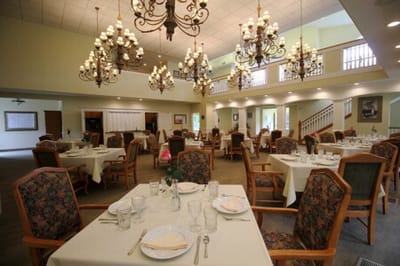 Elegant dining room setup with large chandeliers