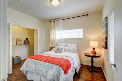 Cozy private room featuring a bed and nightstand