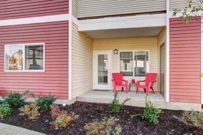 Outdoor seating area with red chairs and plants