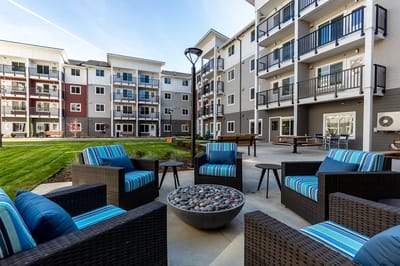 Outdoor seating area with colorful chairs and landscaping