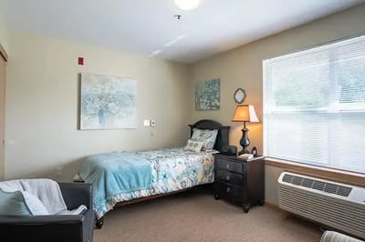 Cozy private resident room with bed and chair