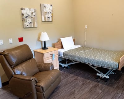 Private resident room with a bed and recliner