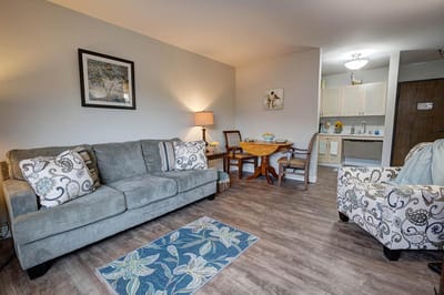 Cozy interior of a resident room with a couch and dining table