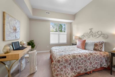 Cozy private room with floral bedding and workspace
